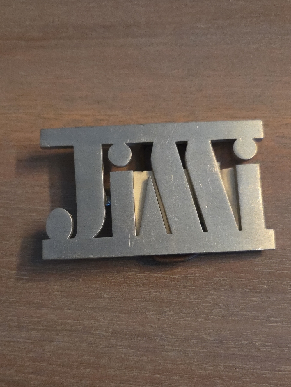 vintage 1970s cut-out name belt buckle spelling out "JIMI"
